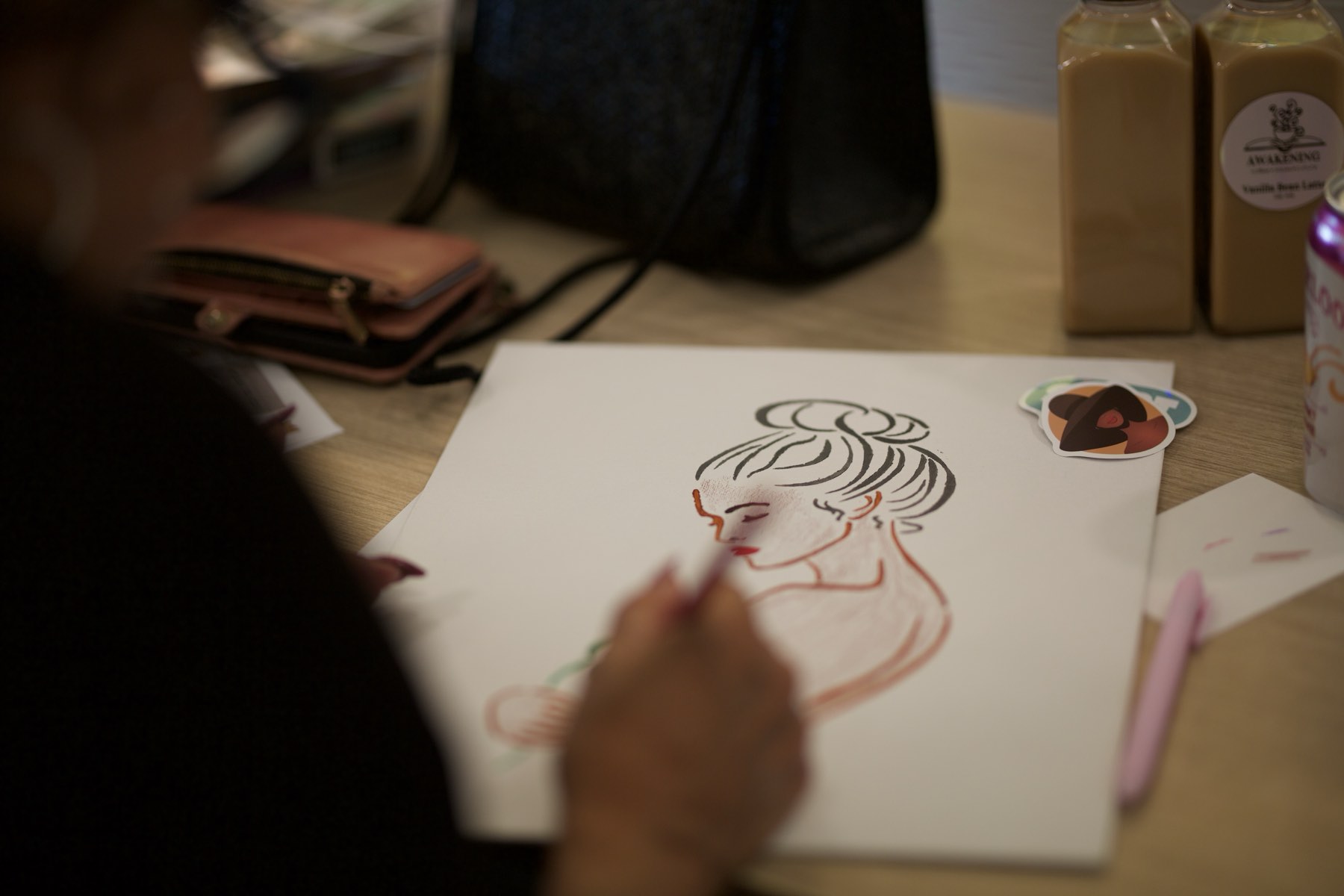 A participant drawing a portrait during a creative session